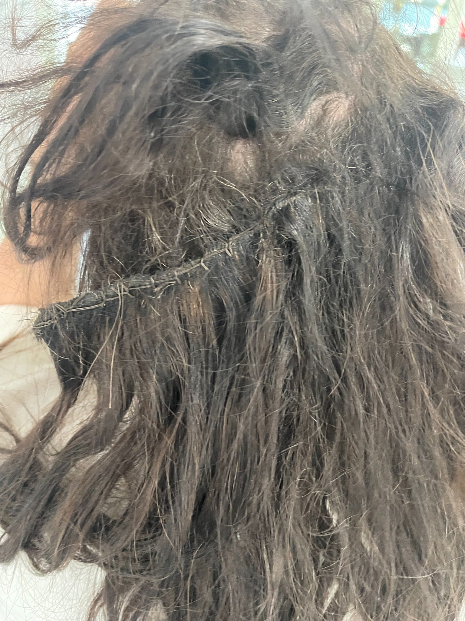 Scalp irritation caused by heavy hair extensions creating excessive tension and discomfort.